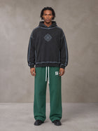 Model wearing the SM Fleece Straight Leg Trousers in Eden Green, front view.