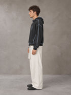 Model wearing SM Eternal Fleur Belted Trousers in Ivory White, side profile.