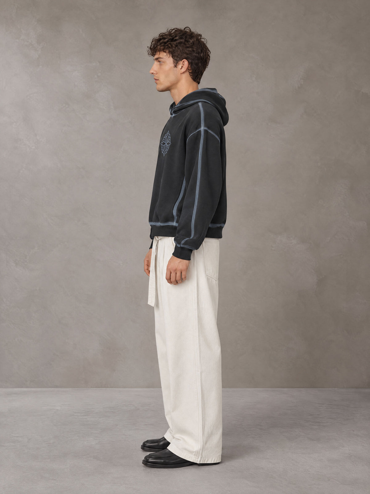 Model wearing SM Eternal Fleur Belted Trousers in Ivory White, side profile.