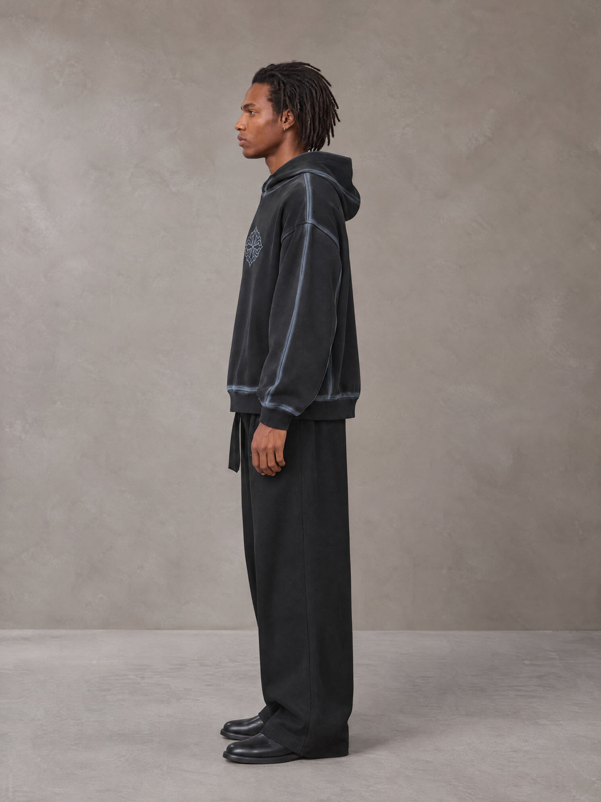 Model wearing SM Eternal Fleur Belted Trousers in Midnight Black, side profile.