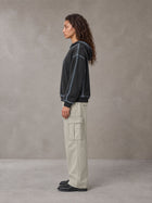 Model wearing SM Eternal Fleur Cargo Trousers in Stone Grey, side profile.