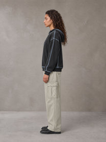 Model wearing SM Eternal Fleur Cargo Trousers in Stone Grey, side profile.