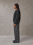 Model wearing SM Eternal Fleur Cargo Trousers in Deep Charcoal, side profile.