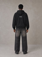 Model wearing SM Fleur Hoodie in Midnight Black, rear view.