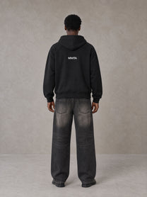 Model wearing SM Fleur Hoodie in Midnight Black, rear view.