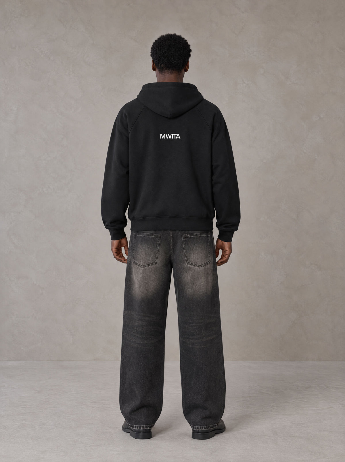 Model wearing SM Fleur Hoodie in Midnight Black, rear view.