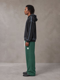 Model wearing SM Fleece Straight Leg Trousers in Eden Green, side profile.