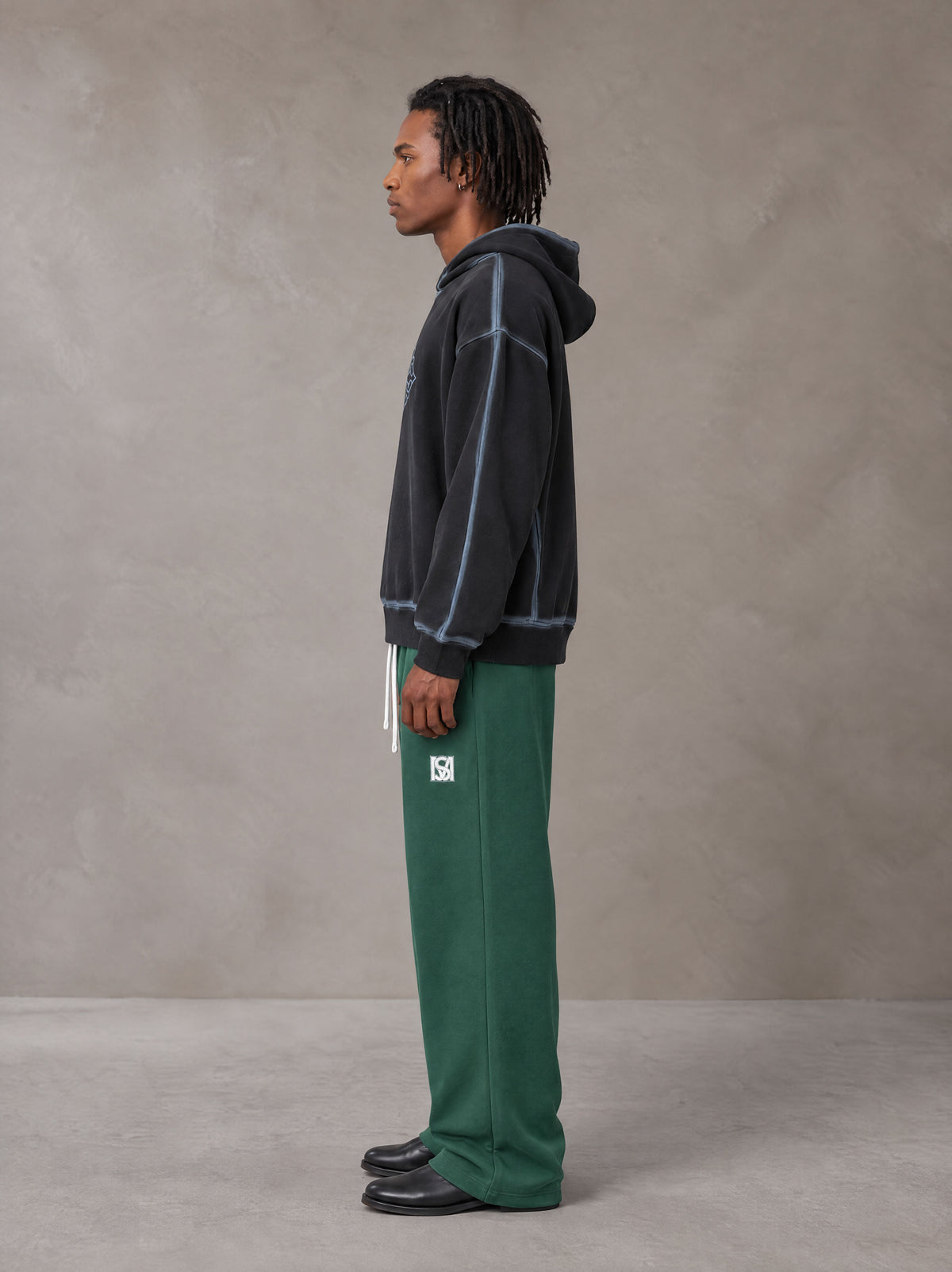 Model wearing SM Fleece Straight Leg Trousers in Eden Green, side profile.