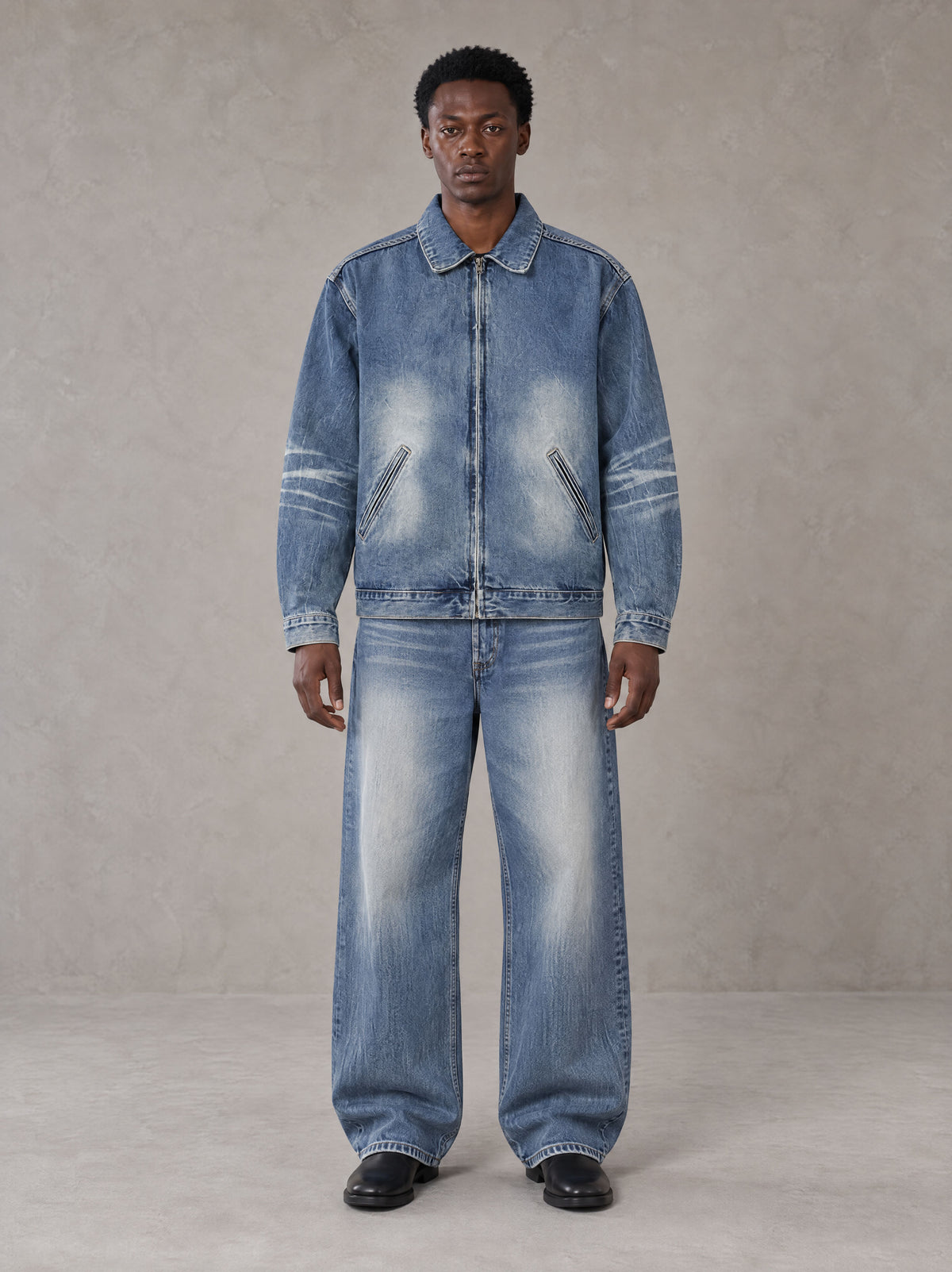 Model wearing the SM Vintage Wash Zip Denim Jacket and SM Heritage Wide Denim Jeans in Marble Blue, front view.