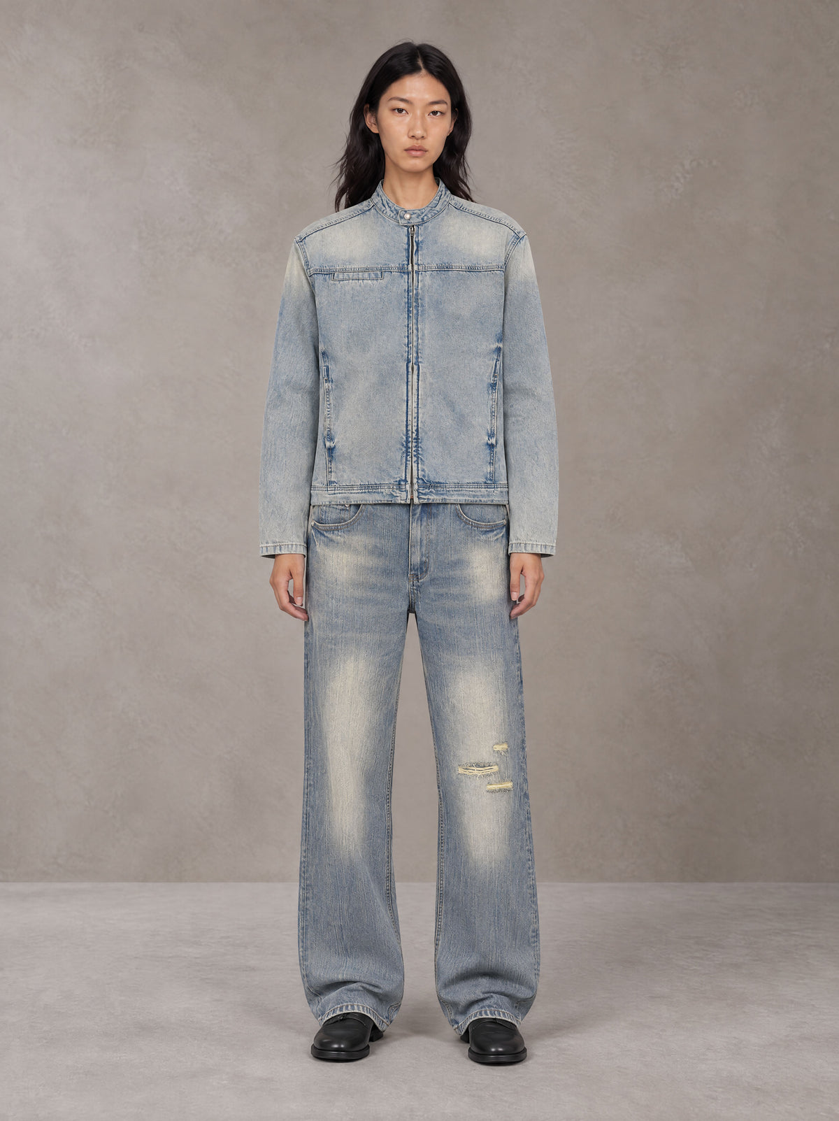 Model wearing the SM Vintage Wash Zip Denim Jacket and SM Heritage Distressed Denim Jeans in Cadet Grey, front view.