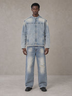 Model wearing the SM Vintage Wash Zip Denim Jacket and SM Heritage Distressed Denim Jeans in Cadet Grey, front view.
