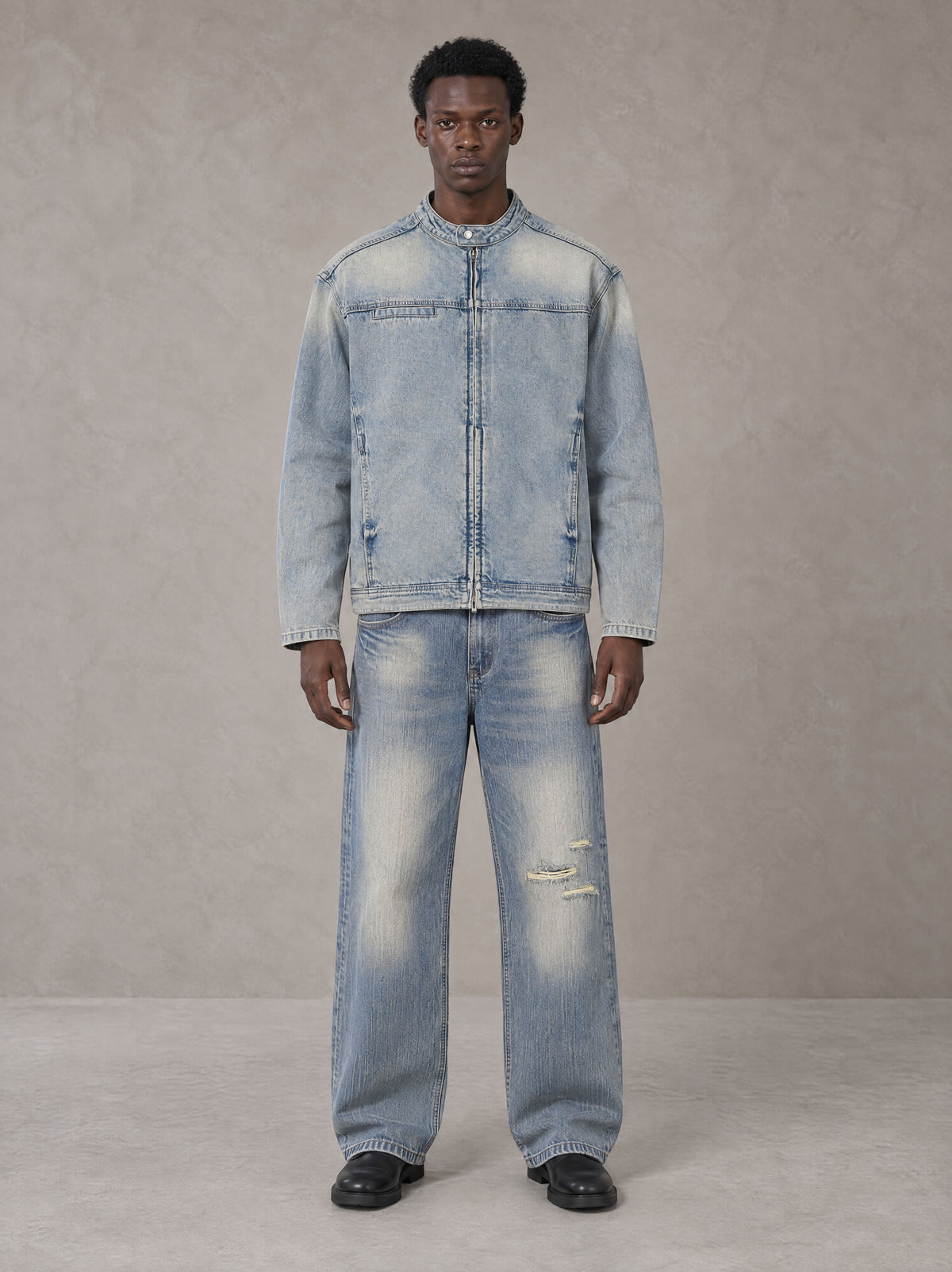 Model wearing the SM Vintage Wash Zip Denim Jacket and SM Heritage Distressed Denim Jeans in Cadet Grey, front view.