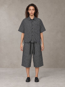 Model wearing the SM Distressed Plaid Boxy Shirt and SM Plaid Capri Shorts in Midnight Black, front view.
