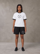 Model wearing the SM London T-shirt in Lucent White with the SM London Shorts in Midnight Black, front view.