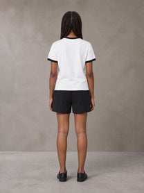 Model wearing the SM London T-shirt in Lucent White with the SM London Shorts in Midnight Black, rear view.