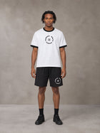 Model wearing the SM London T-shirt in Lucent White with the SM London Shorts in Midnight Black, front view.