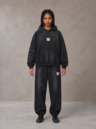 Model wearing the SM Monkey Washed Fleece Hoodie in Midnight Black with the SM Monkey Washed Jogger Sweatpants in Midnight Black, front view.