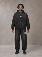 Model wearing the SM Monkey Washed Fleece Hoodie in Midnight Black with the SM Monkey Washed Jogger Sweatpants in Midnight Black, front view.