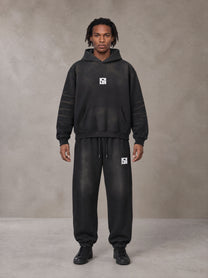 Model wearing the SM Monkey Washed Fleece Hoodie in Midnight Black with the SM Monkey Washed Jogger Sweatpants in Midnight Black, front view.