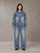 Model wearing the SM Vintage Wash Zip Denim Jacket and SM Heritage Wide Denim Jeans in Marble Blue, front view.