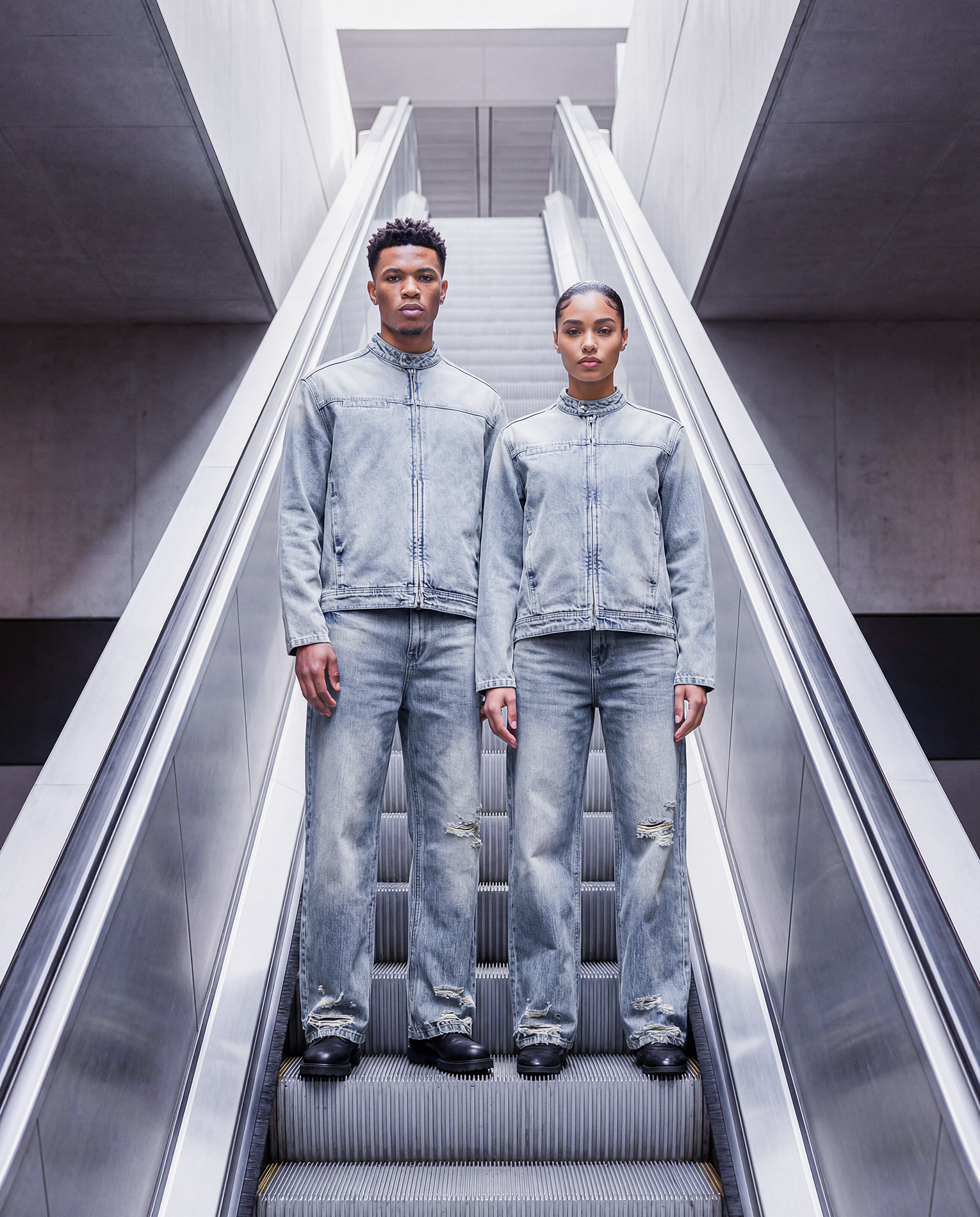 Hero - Two models wearing denim set on elevator.